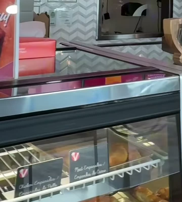Vicky Bakery empanada display case with chicken and beef empanadas.